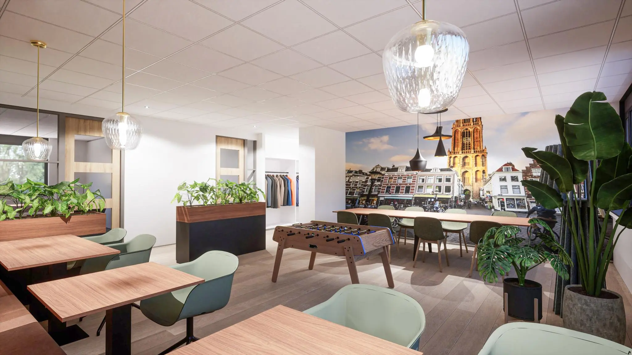 Moderne kantoorruimte met zitplekken, planten, een tafelvoetbaltafel en een grote muurfoto van de Domtoren aan de Burgemeester Verderlaan.